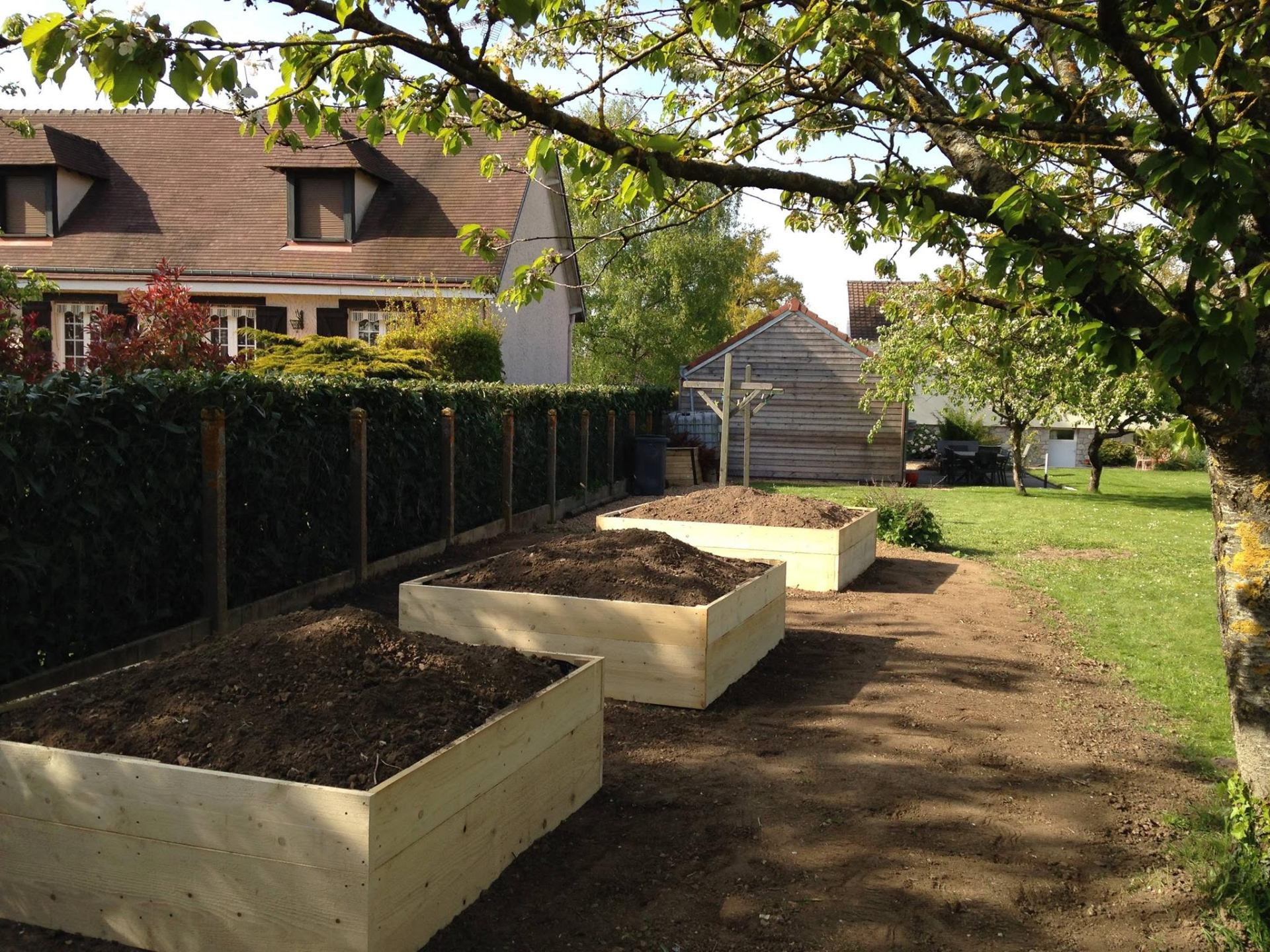 Carrés potagers en bois installés lors d'une remise en état de jardin